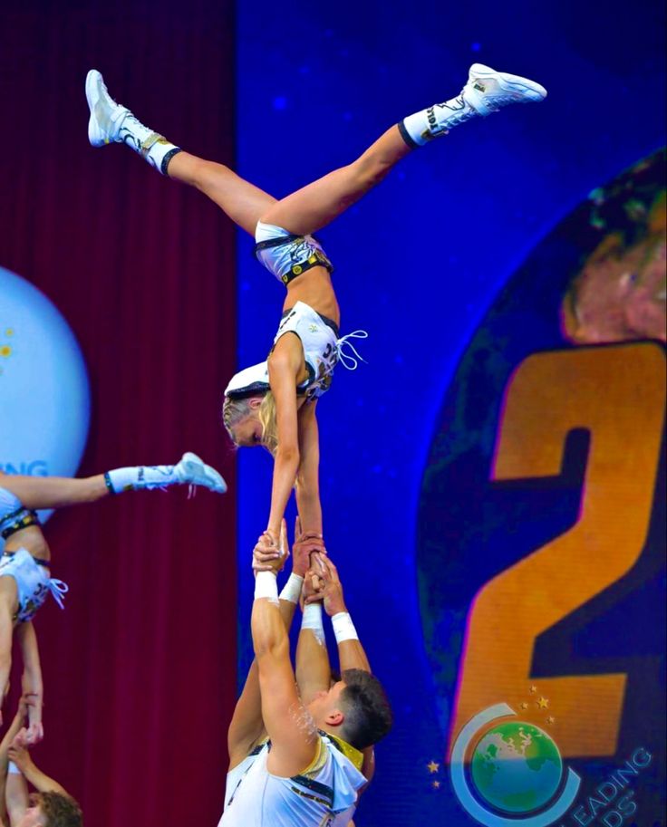 Competitive cheerleaders in a handstand stunt