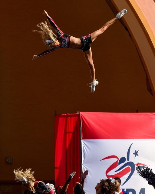 cheerleader in the middle of a backflip basket