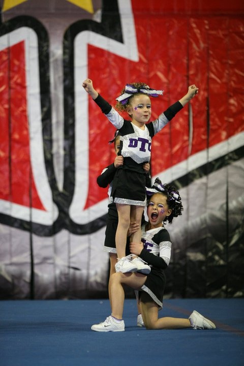 young cheerleaders doing a stunt for cheerleading fundraiser ideas