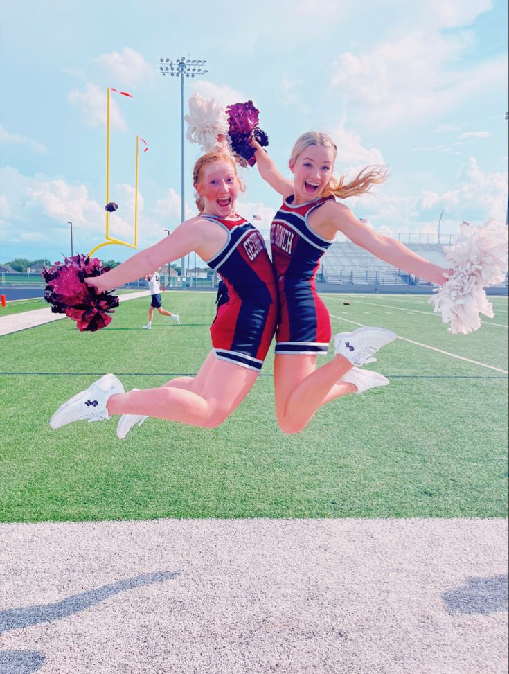 Cheerleaders doing a chest bump